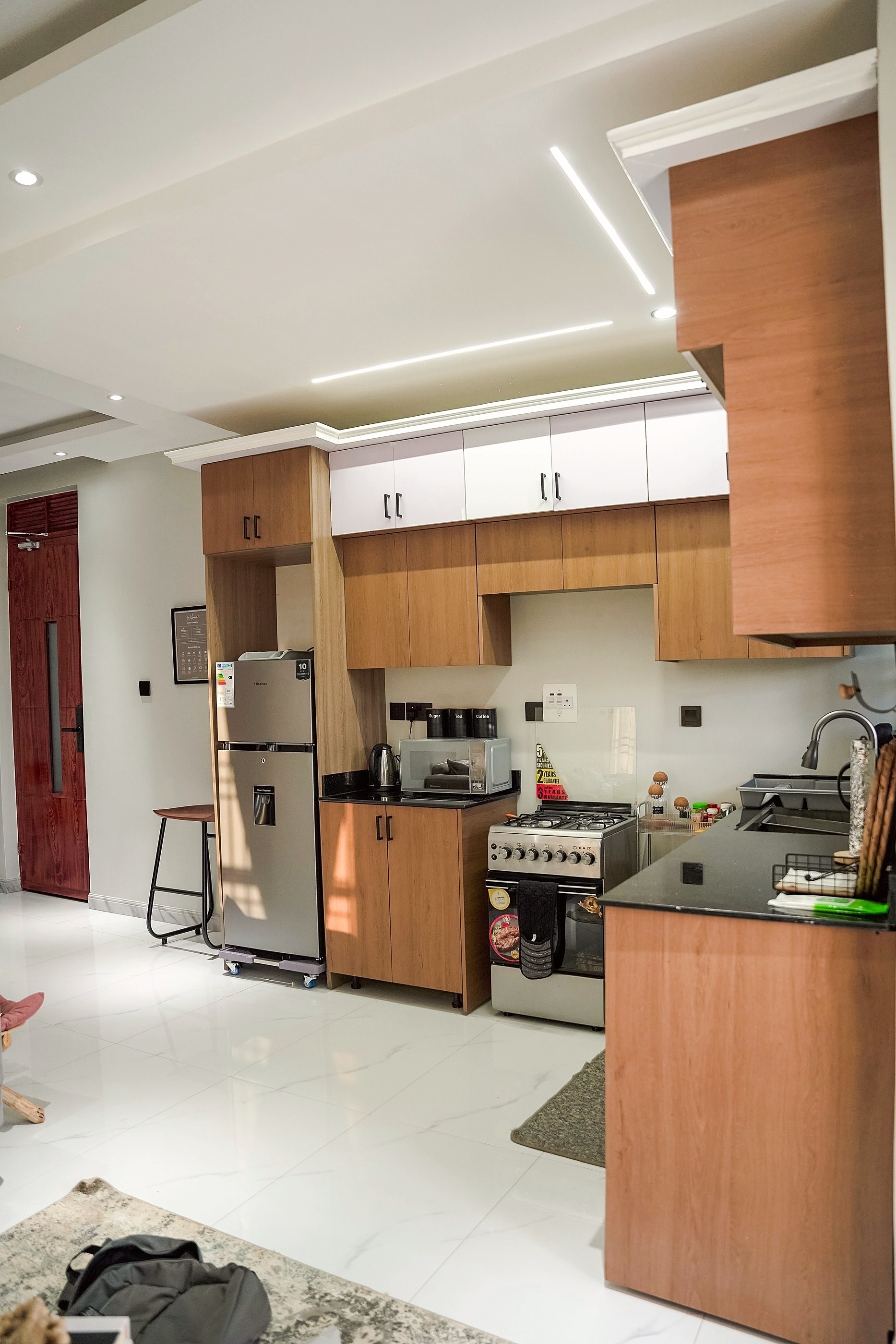 The open kitchen under a lit ceiling channel