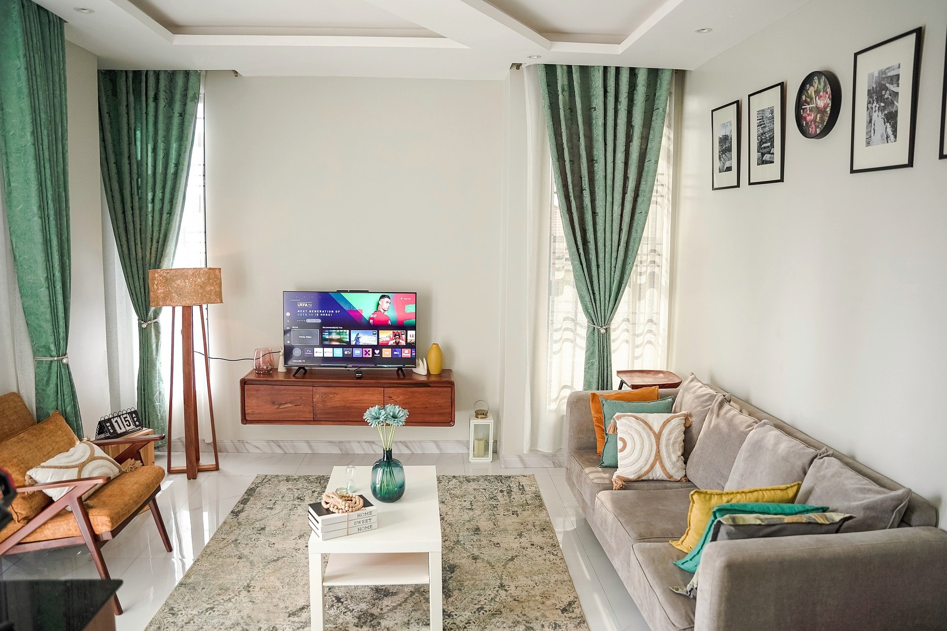 The living room in daylight with sofa, coffee table and television